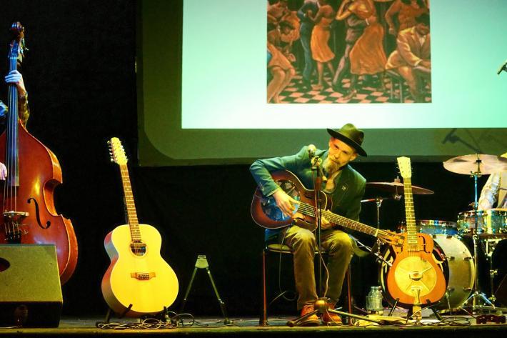 Mark Harrison and band performing on stage