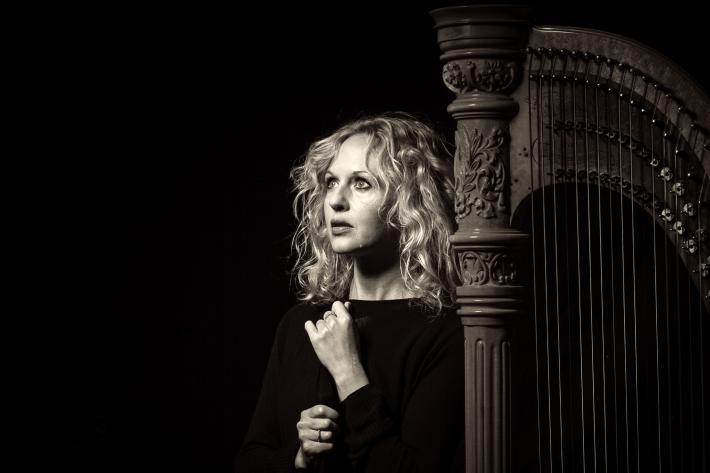 Black and white portrait of Ruth Wall with her concert harp