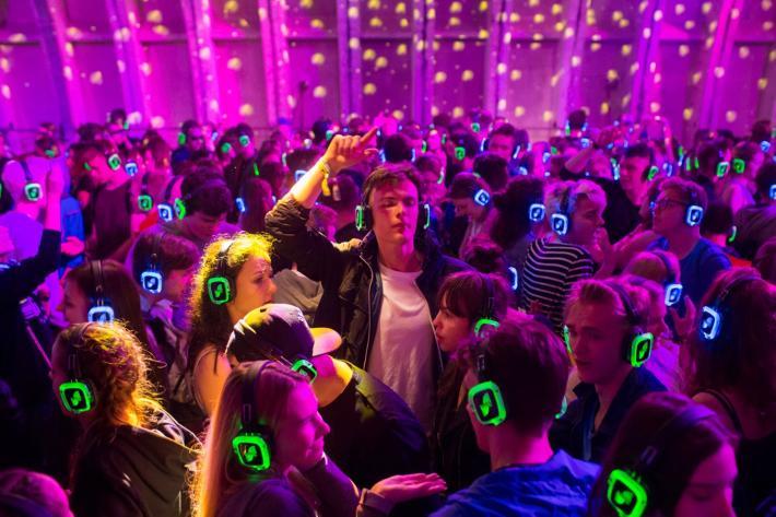 Group of people dancing with mobile phones