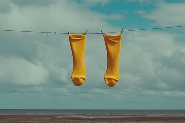 A pair of yellow stockings pegged on a line