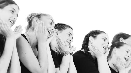 A group of girls rehearsing a musical number